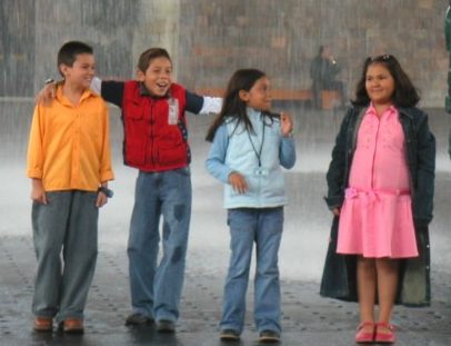 Mexican kids playing in the rain. Great example of Hispanic culture.